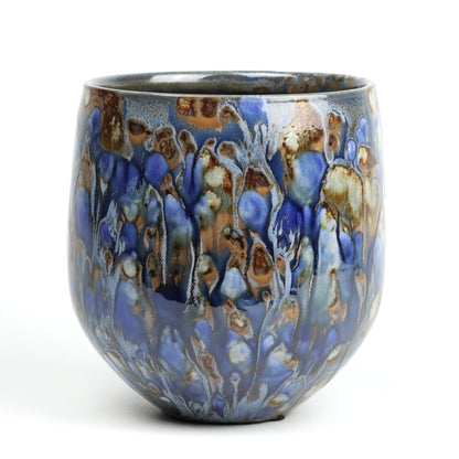 Ceramic pot with blue and brown glaze on a white background